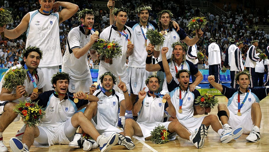 Members of the Argentina basketball team pose for photographers with their gold medals following a 84-69 win over Italy in of game at the Olympic Indoor Hall during the 2004 Olympics in Athens, Greece on Saturday, Aug. 28, 2004. (AP Photo/Michael Conroy)